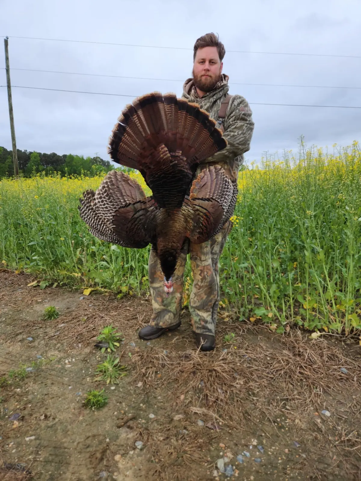 Collin holding a wild turkey outdoors