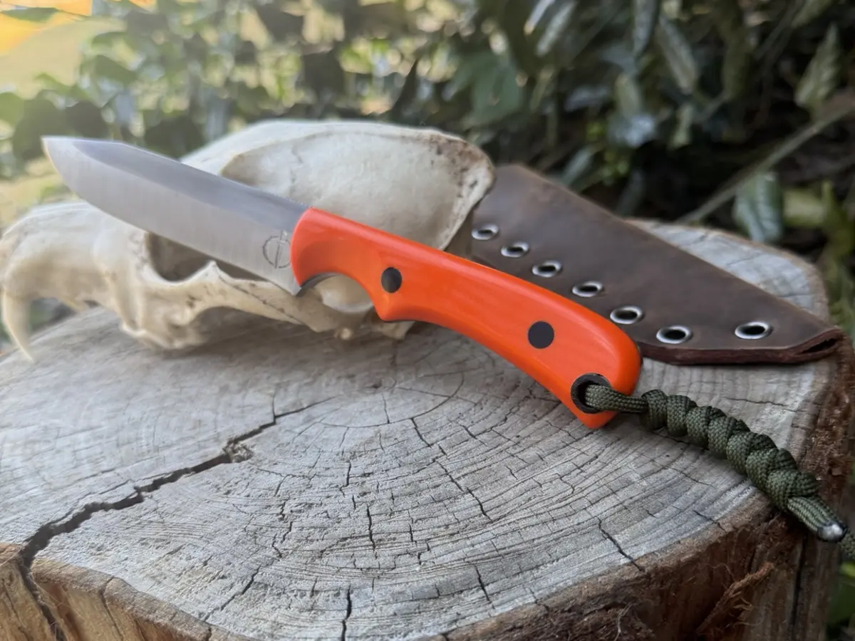 The Marne handmade hunting knife with a blaze-orange G10 handle