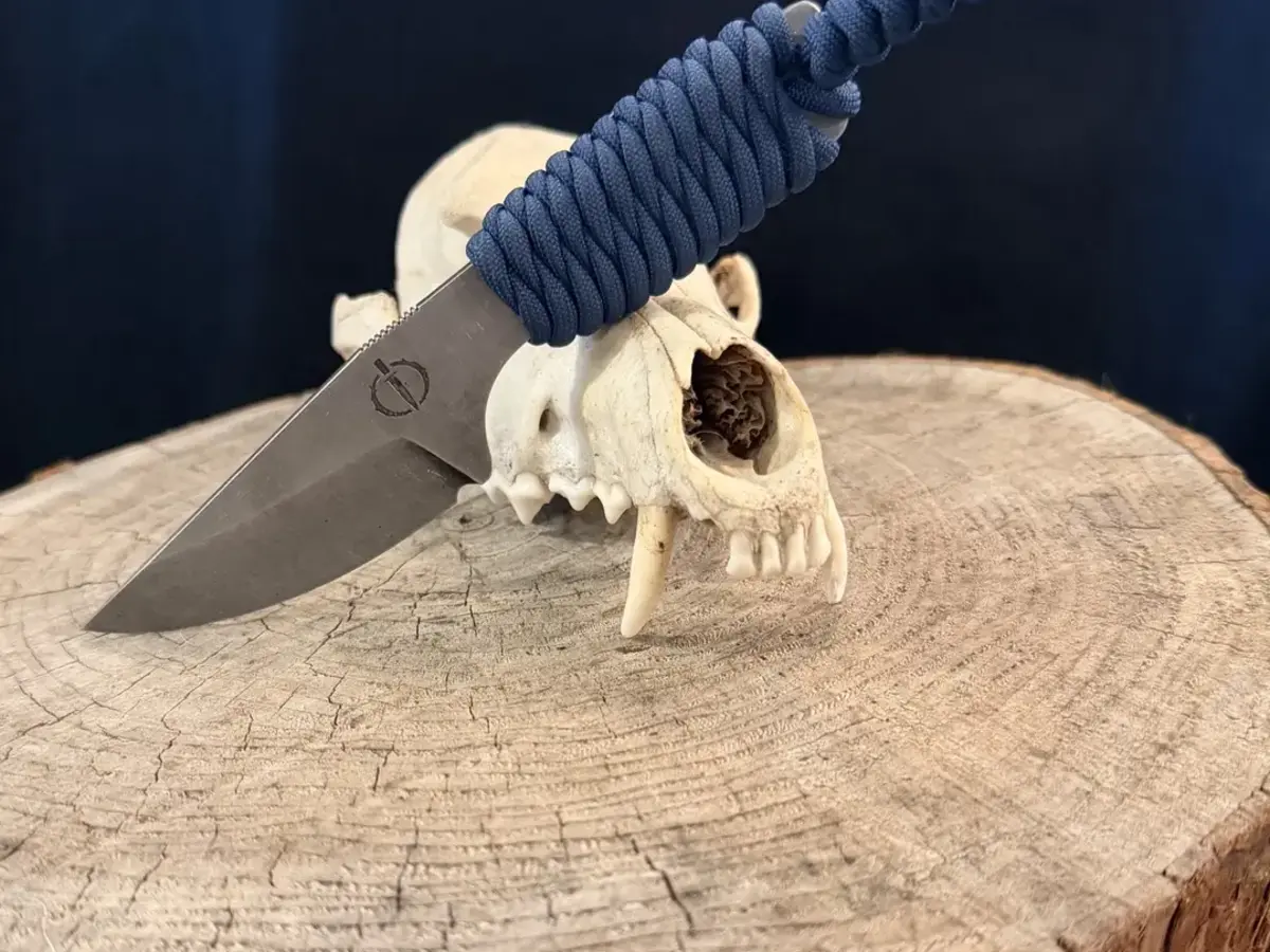 The Mini Crusader with a navy paracord-wrapped handle