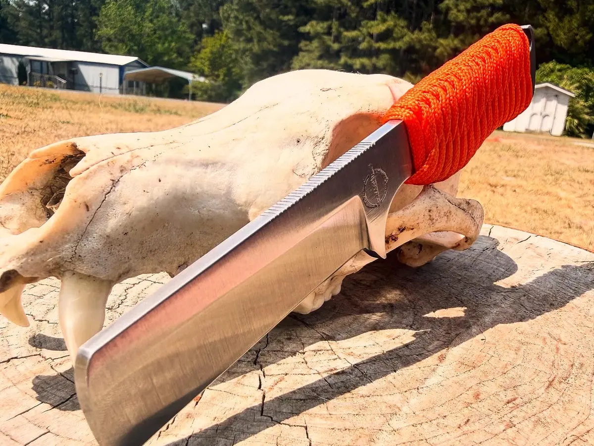 The Rancher with a bright orange paracord-wrapped handle