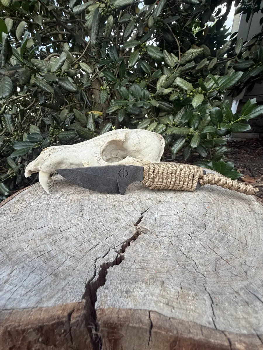 The Mini Crusader with a tan paracord-wrapped handle
